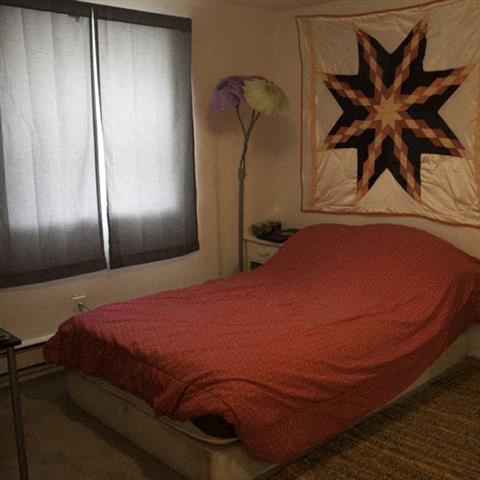 a bedroom with a bed and a window