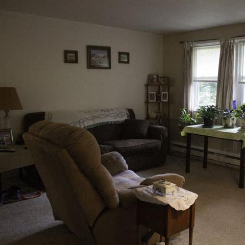 a living room filled with furniture and a window