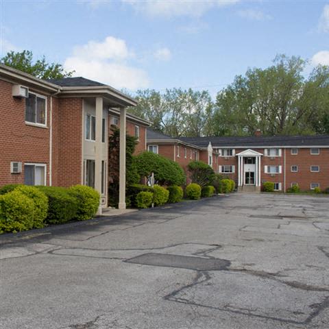 a parking lot in front of an apartment building