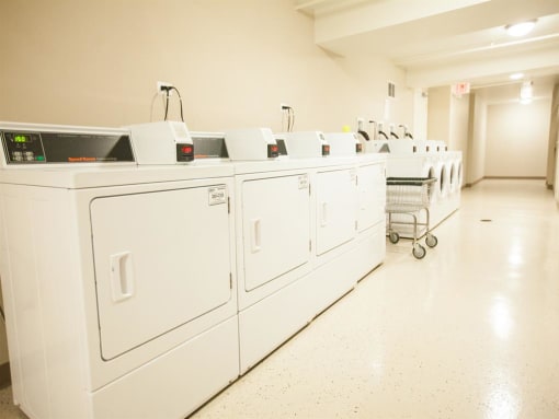 Laundry Center with Machines Next to Folding Counter at The Greenway at Carol Stream, Carol Stream
