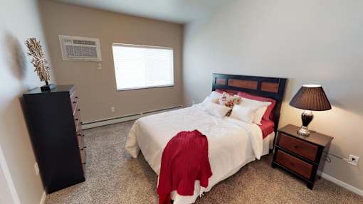 bedroom with red and white bedding