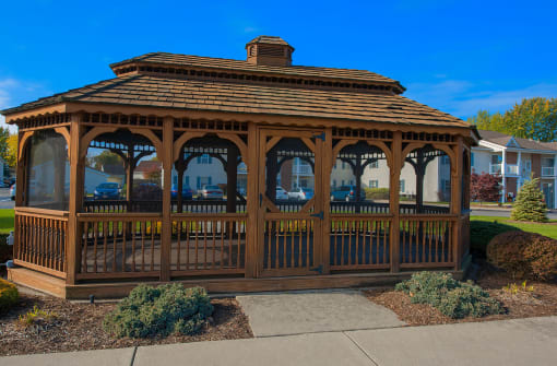 a gazebo in a yard with a sidewalk