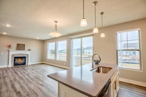 Kitchen and living room of Home For Rent in Holt Michigan | Aspen Lakes Estates
