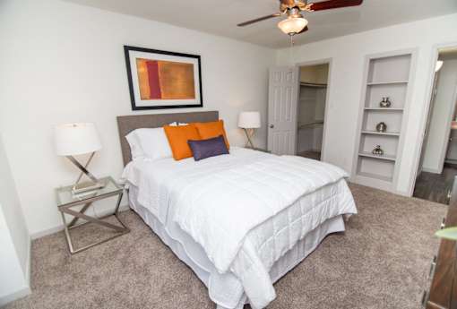 View of bedroom showing built-in shelving and walk-in closet.