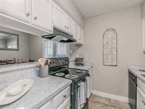 Apartment kitchen featuring upgraded appliances and lighting
