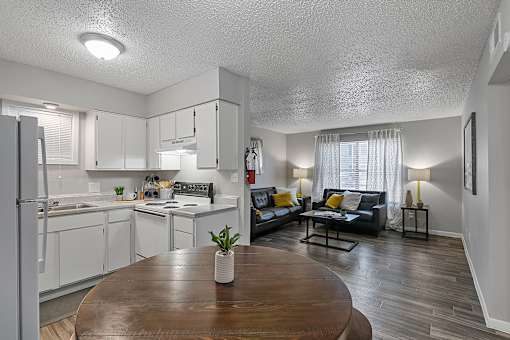 Open-concept living room with modern furniture and natural light at Sage Creek Apartments in Victoria TX