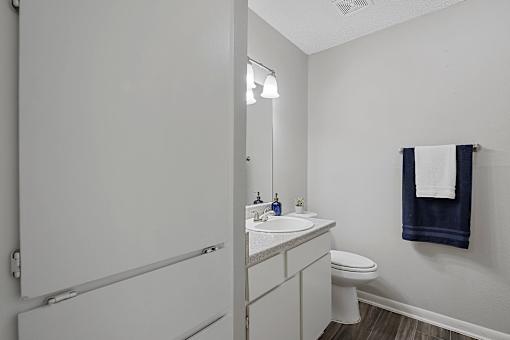 bathroom with large mirror, vanity lighting, and updated fixtures