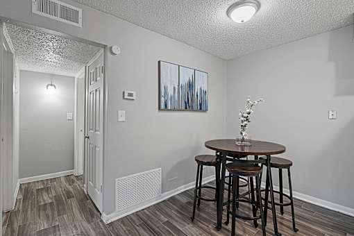 Dining nook with modern décor and dark wood flooring