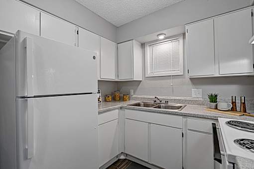 Kitchen with white cabinetry, tile flooring, and breakfast bar