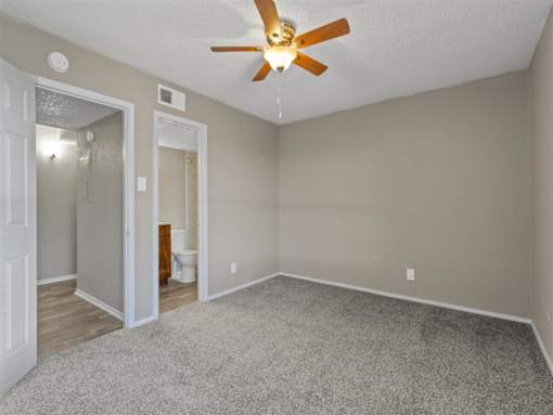 Bedroom with light walls at Verano Oaks Apartments