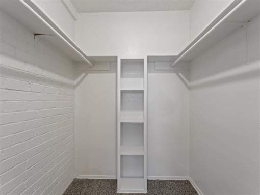 Walk-in closet with built-in shelving at Verano Oaks Apartments
