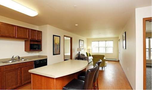 A kitchen with wooden cabinets and a white countertop.