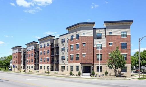 Kingston Village - modern apartment buildings with brick and stone exteriors.