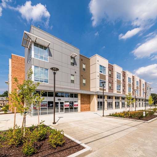 A modern building with a parking lot in front.