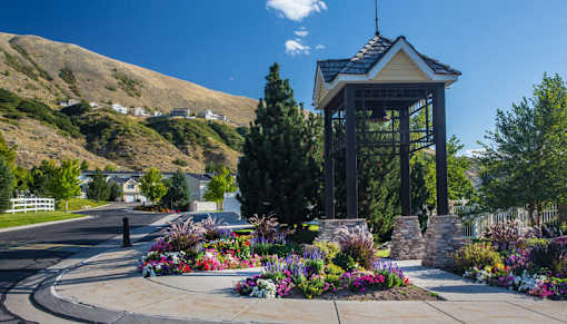 Bell tower pavilion with vibrant flower gardens at Liberty Hill Apartments, Draper, UT 84020