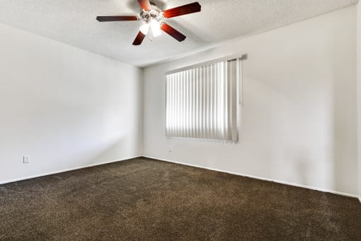 Bedroom with ceiling fan, carpeted flooring, vertical window coverings