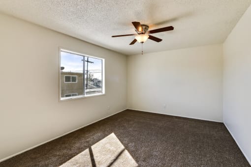 Bedroom with ceiling fan and carpeted floors