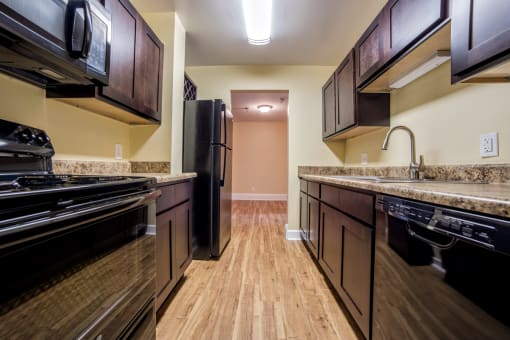 Updated Kitchen With Black Appliances at The Plaza at Library Square, Indiana, 46204