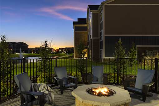 round firepit with dark chairs at dusk at Thirteen01 at Hartman Lakes, Shiloh, IL, 62269