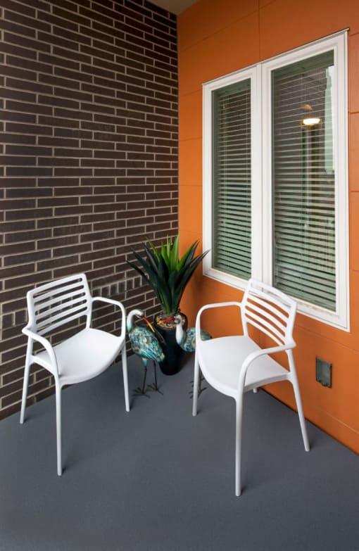 Thh Wilmore patio with two chairs and a plant