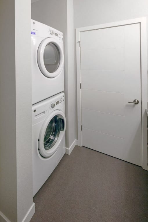 The Wilmore Laundry room with stacked washer and dryer