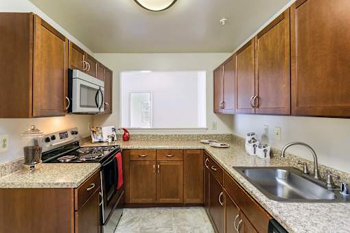 Kitchen with cabinets at The Apartments at Owings Run, Maryland, 21117