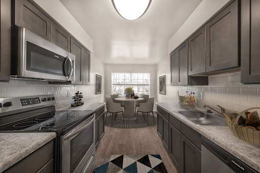 Kitchen with mosaic tiles and cabinets at The Apartments at Owings Run, Maryland, 21117