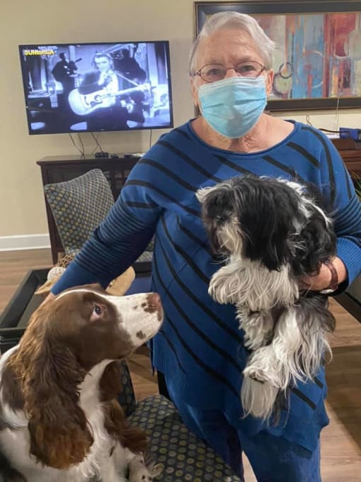 Senior Carrying Two Dogs at Savannah Court of Camilla, Camilla, GA