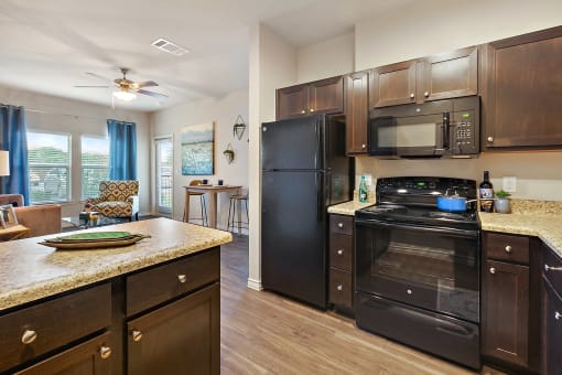 Apartments for Rent in New Braunfels TX - Canyon House - Modern Kitchen with Dark Wood-Style Cabinets