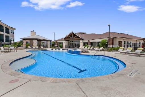 Apartments in San Marcos for Rent-Sadler House-Pool- Large Pool, White and Yellow Pool Lounge Chairs, and Jacuzzi
