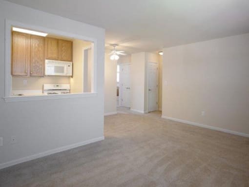 kitchen with white appliances and wooden cabinets.