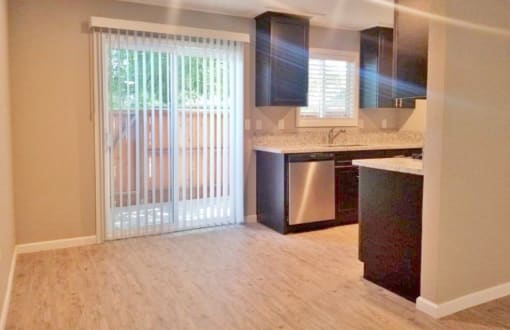 View of dining and kitchen area and sliding glass door leading to private patio