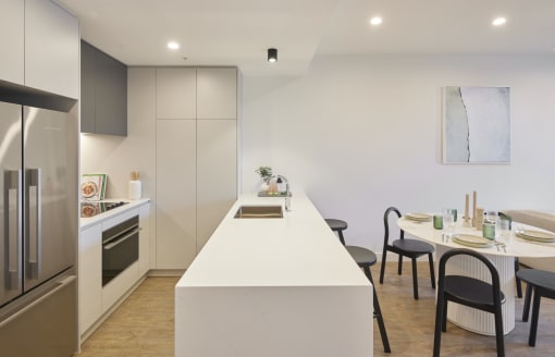 a kitchen and dining area with a white counter top