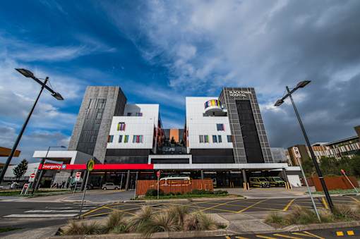 A modern building with a red awning in front of it.