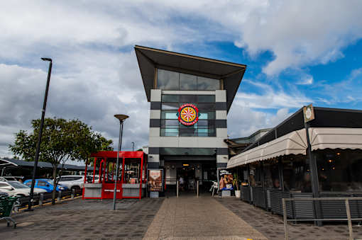 A modern building with a red and white sign on the front.