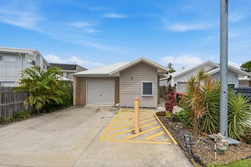 A residential area with a house, garage, and a driveway.