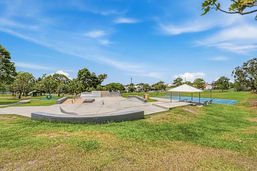 A park with a playground and a basketball court.