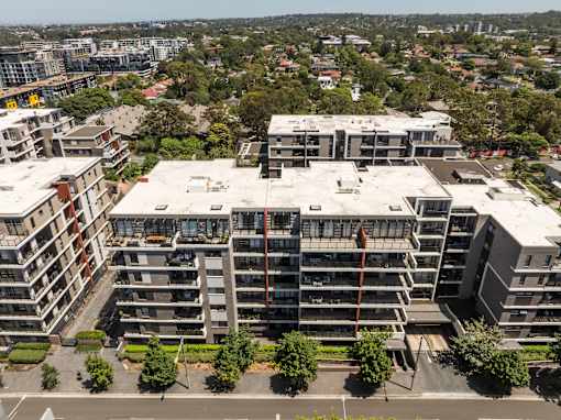 A large apartment complex with multiple buildings and balconies.