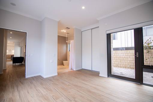 A room with wooden floors and white walls.