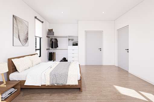 A bedroom with a bed, nightstand, and a painting on the wall.