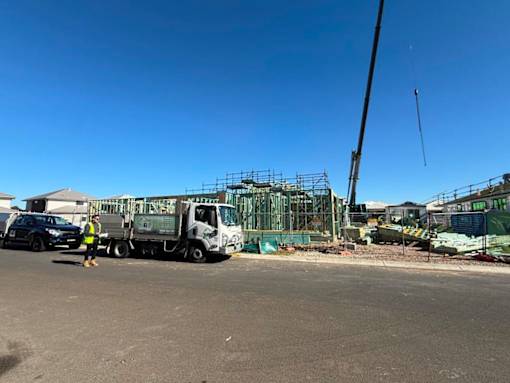A construction site with a truck and a crane.