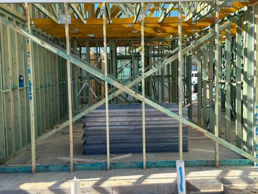 A construction site with wooden beams and concrete slabs.