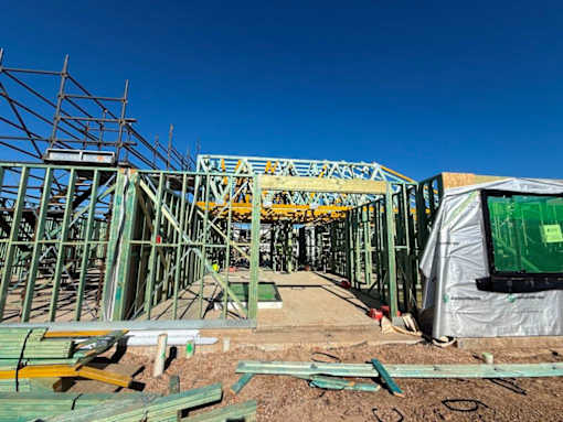 A construction site with a large metal framework and scaffolding.