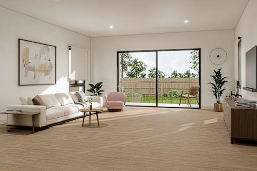 A living room with a white sofa, a pink chair, a wooden table, and a flat-screen TV.