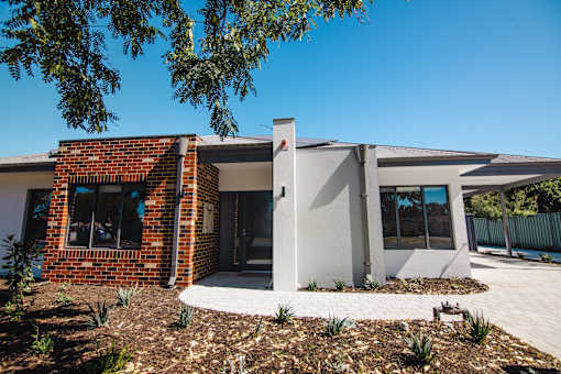 A modern house with a white and brick exterior.