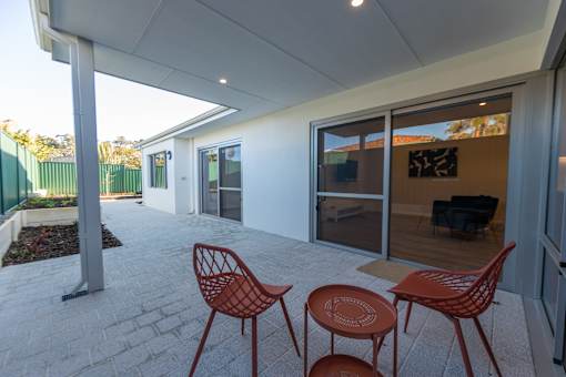 A patio with a table and chairs.