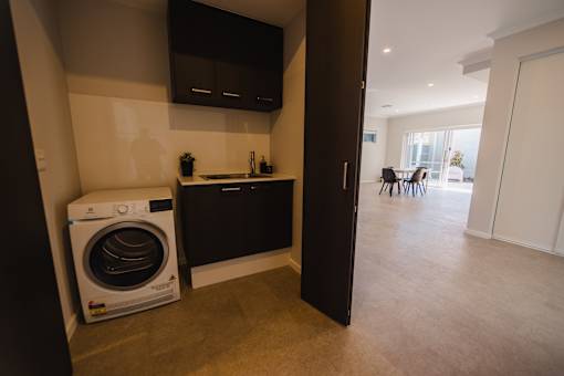 A washing machine is sitting in a laundry room.