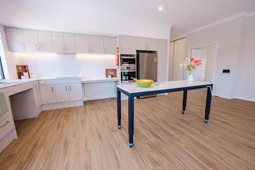 A kitchen with a table and chairs in the middle of the room.