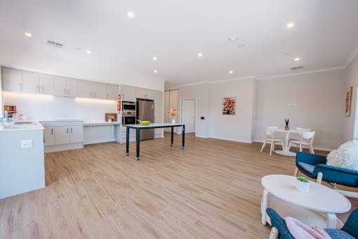 A modern kitchen with a dining table and chairs.