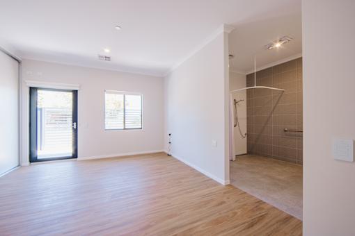 A room with wooden floors and white walls.
